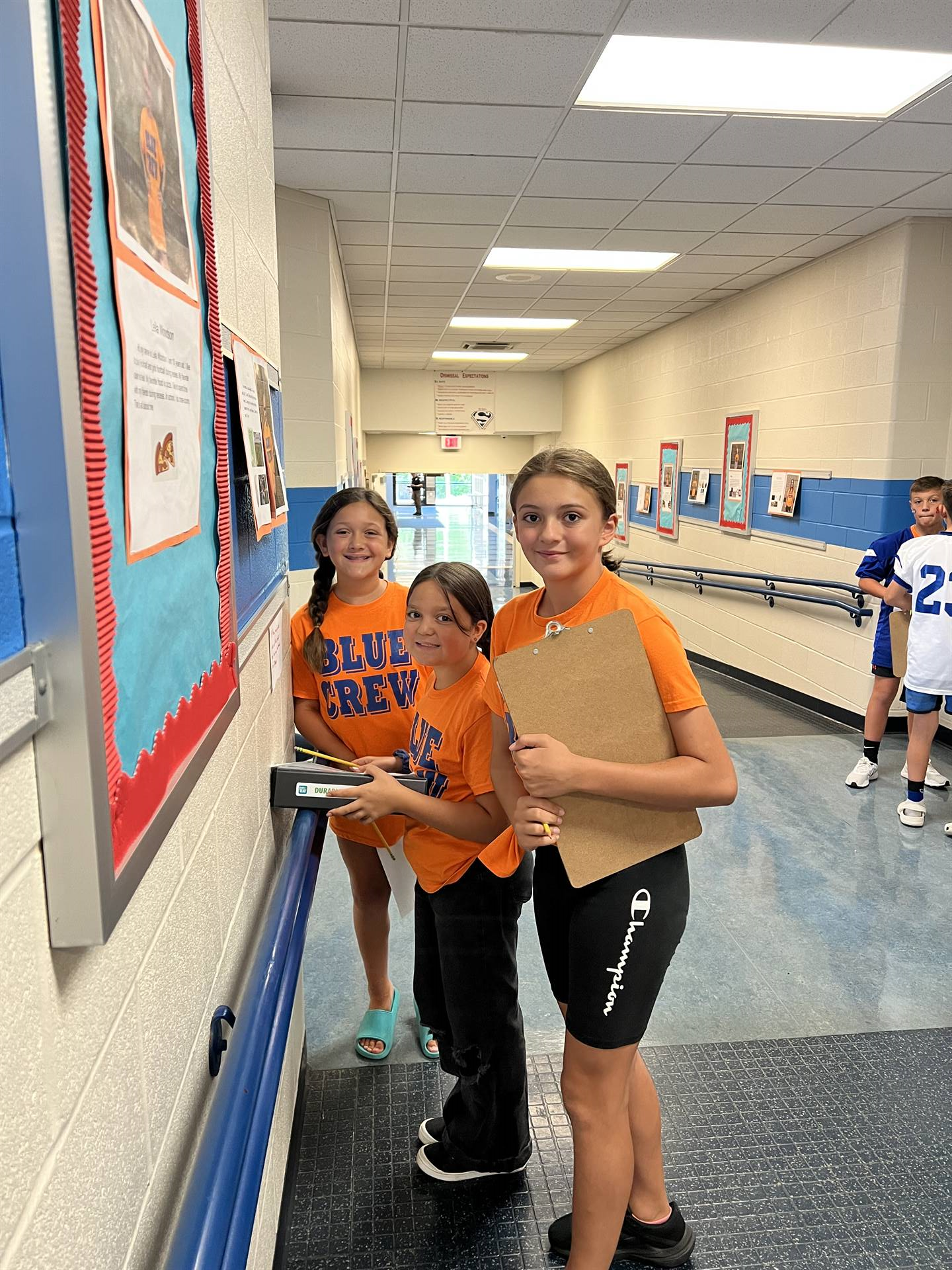 SAES Blue Crew students posing for a photo will assisting throughout the school